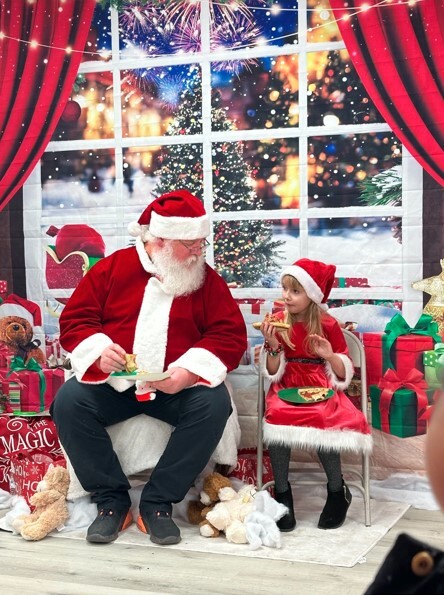 Santa and his helper enjoy some pizza.