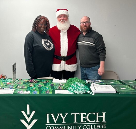 Santa visits Ivy Tech staff Clarissa Andrews, Director of Adult Recruitment, and Joe Moore, Veterans Specialist.