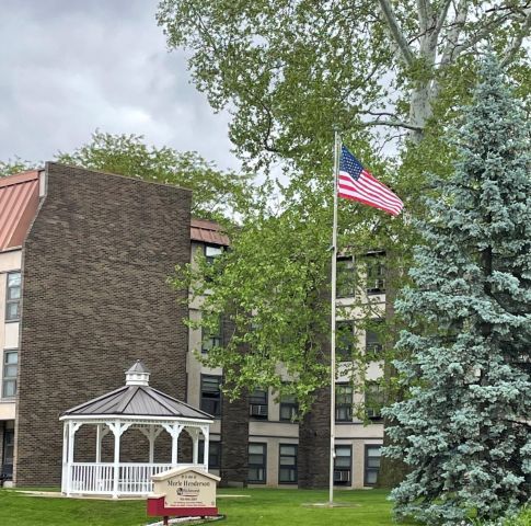 A view of the Merle Henderson Flag, in front of the building.